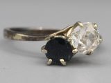 an image of a close up of a ring with a diamond and a sapphire