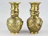 pair of antique brass vases with dragon heads on them