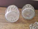 two empty glass jars sitting on a wooden table
