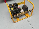 a small yellow cart with a small engine on it