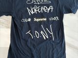 blue t - shirt with white writing on it on a marble surface