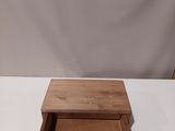 a small wooden box sitting on top of a white table
