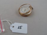 a small gold pocket watch with a price tag on it