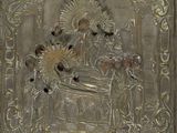 brass plate with a picture of a woman and a man on a throne