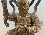 statue of a man sitting on a chair with a snake in his hand