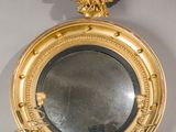 a gold mirror with an eagle on top of it