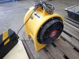 a yellow blower sitting on top of a pallet