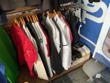 a lot of clothes hanging on a rack in a store