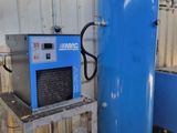 a large blue tank sitting next to a blue machine