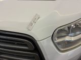 a close up of a white car with a sticker on the front of it