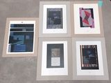 quatre tableaux encadrés représentant différents types d'œuvres d'art, posés sur une table