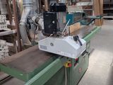 a machine that is working on a piece of wood