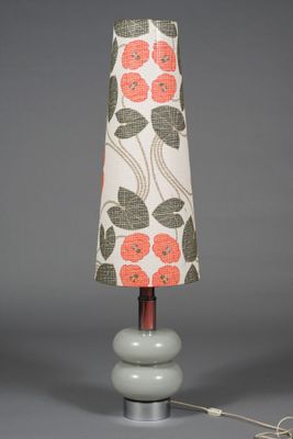 an image of a table lamp with a red flower shade on it