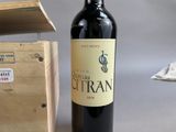 a bottle of wine sitting next to a wooden box