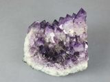 a close up of a piece of amethorate on a gray surface