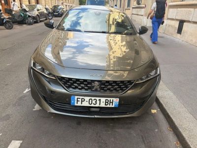 the car is parked on the side of the street in the city