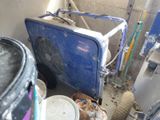 an image of a room with a blue cooler and a bucket