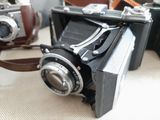 two old cameras sitting next to each other on a table