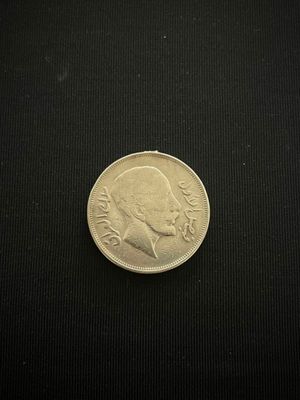 a coin that is sitting on a black surface