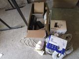 a box of electronics and a box of wires on the floor
