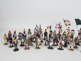 the toy soldiers are all dressed up in uniforms and holding flags