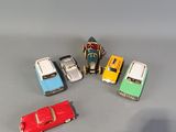 several toy cars are lined up in a row on a gray surface
