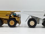 two toy trucks that are sitting next to each other