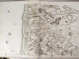 an old book with a drawing on it sitting on a table