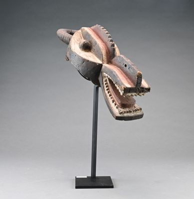 sculpture of a dragon ' s head on a stand with a gray background