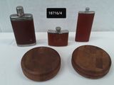 three flasks and two hip flasks sitting on a table