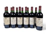 six bottles of red wine lined up in a row on a white surface