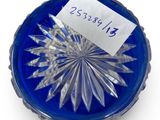 a blue glass bowl with a label on it