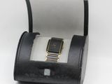 an image of a watch in a black case on a white surface