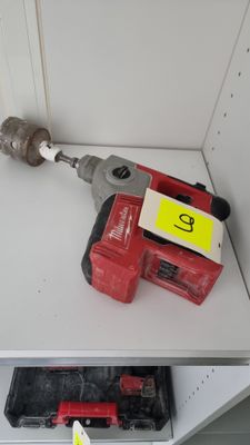 a drill and a hammer on a shelf in a room