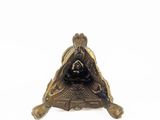 a small statue of a man sitting on a turtle