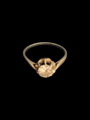a close up of a gold ring with a diamond on it