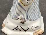 a white vase with a blue and white design on it