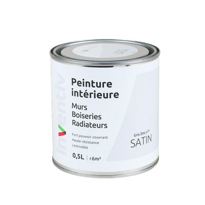 un pot de peinture posé sur une table blanche