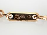an image of a gold chain bracelet with a tag on it