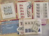 many different types of stamps and envelopes on the table