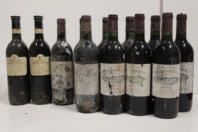 several bottles of wine are lined up on a white surface