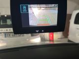 the rear view mirror of a car with a gps device attached to it