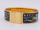 an image of a gold bracelet with a blue and yellow design