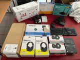 many boxes of headphones and a keyboard on a table