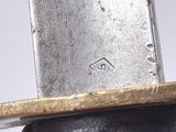 a close up of a knife with a wooden handle