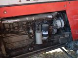 a red and white truck with a engine in it ' s back