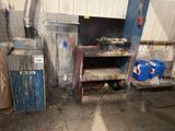 a dirty kitchen with a stove and cabinets in it