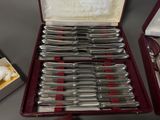 a lot of silverware in a case on a table
