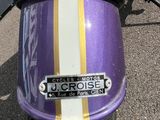 a purple motorcycle with a yellow and white stripe on it