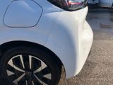 a close up of a white car parked in a parking lot